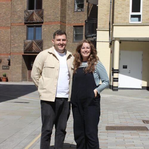 Zero Gravity team members Fi and Alex squinting in the sun outside the office